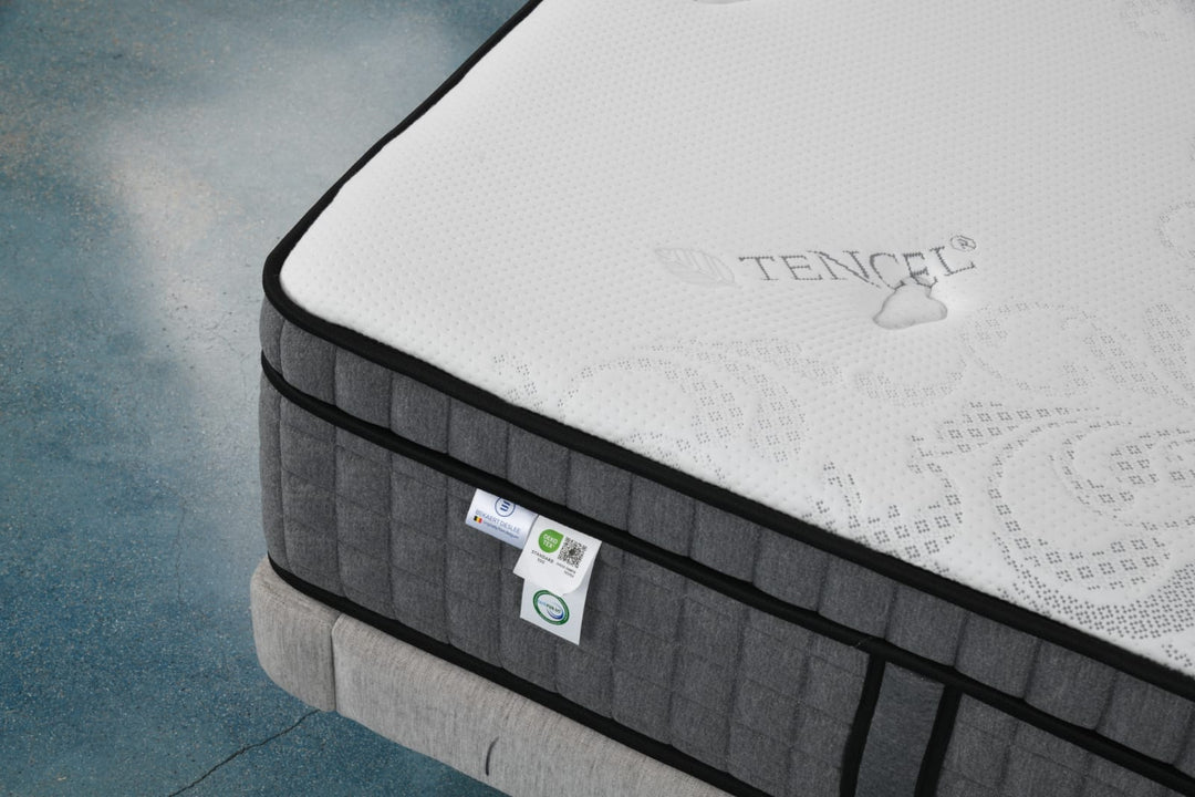 Close-up of a Tencel top mattress with gray quilted sides on a bed frame