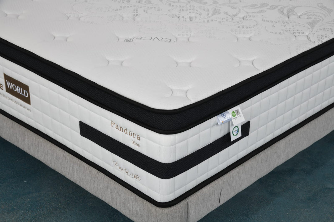 Close-up of a white and black Pandora firm mattress with quilted pattern on a bed base