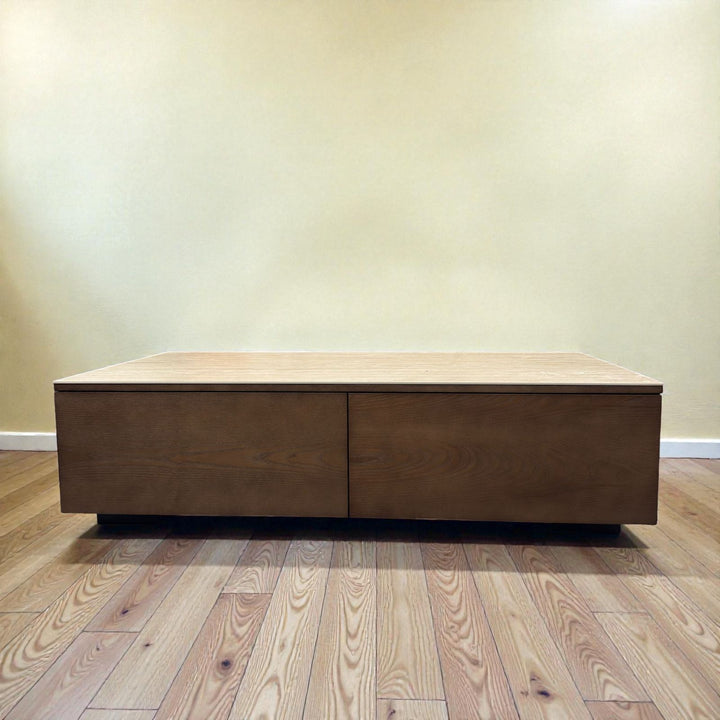 Modern rectangular wooden coffee table with storage on hardwood floor