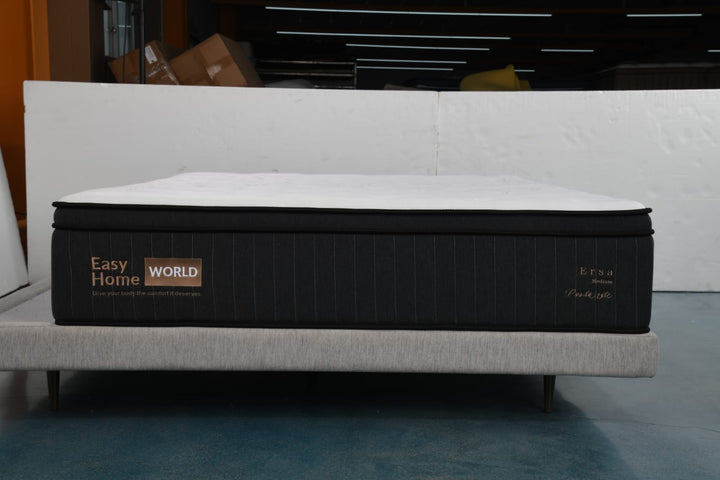 Modern black and white mattress with Easy Home World logo on a grey upholstered bed base