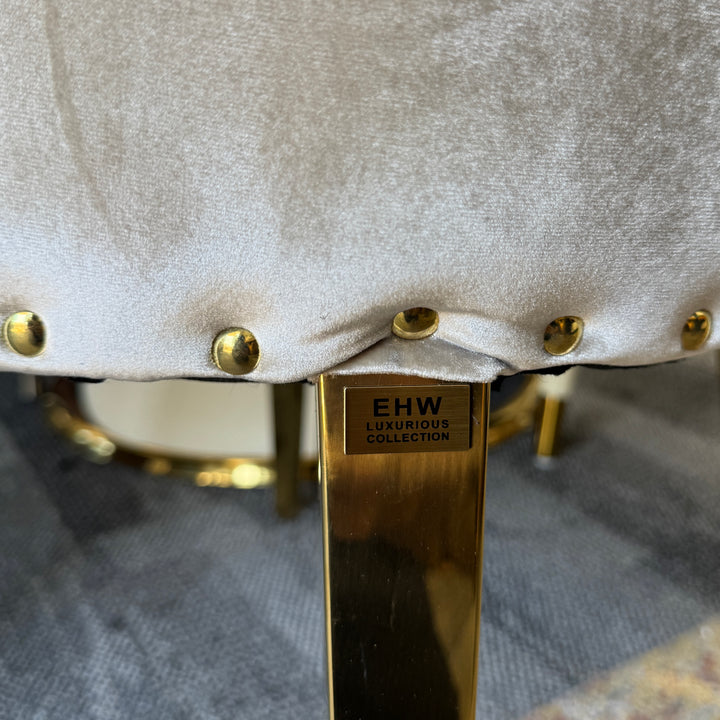 Velvet upholstered chair with gold metal legs and decorative studs, luxury home furniture