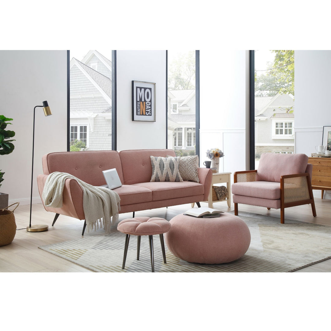 Modern living room with pink sofa set, armchair, ottoman, and large windows